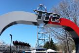 Top Thrill 2 roller coaster entrance sign at Cedar Point, with the coaster vehicle in the background