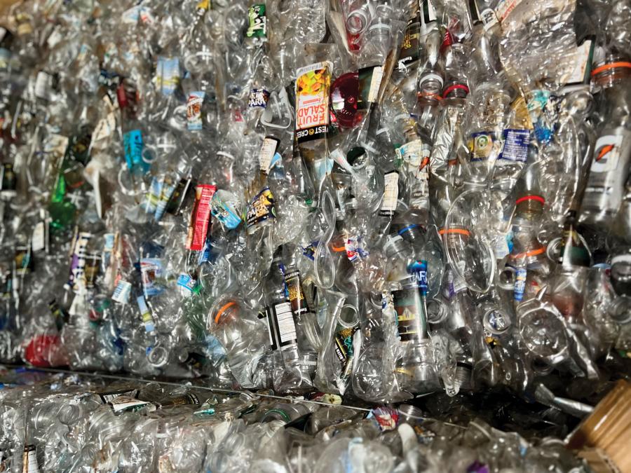 Different types of compressed plastic bottles inside Knoebels Amusement Resort's recycling center