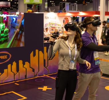 Un asistente y un representante de Spree prueban los cascos de realidad virtual
