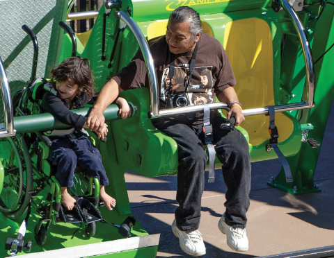 Child in wheelchair enjoys Zamperla Happy Swing at Give Kids The World