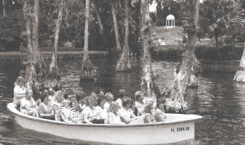 Historic photo of guests riding the old boats at Cypress Gardens.