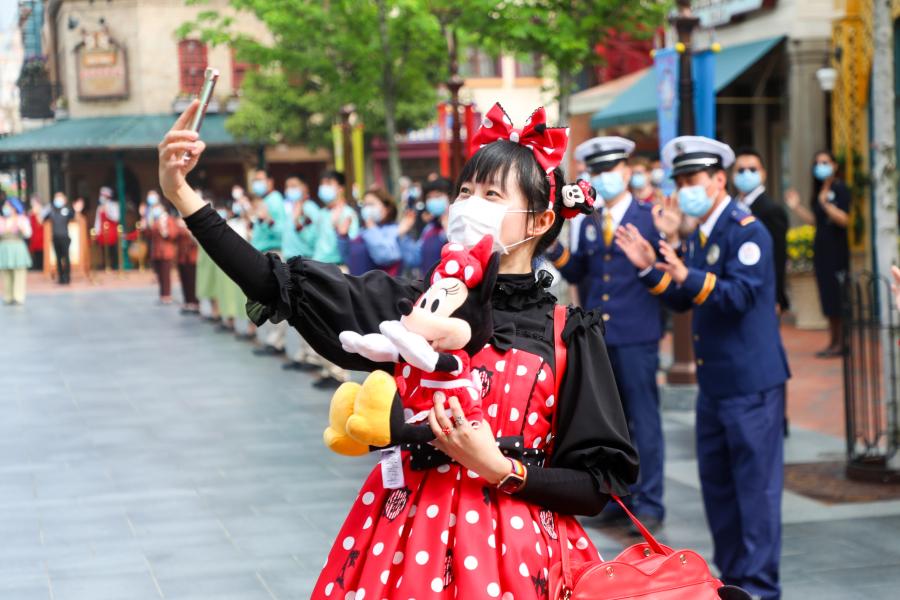 A guest at Shanghai Disneyland poses with a mask on