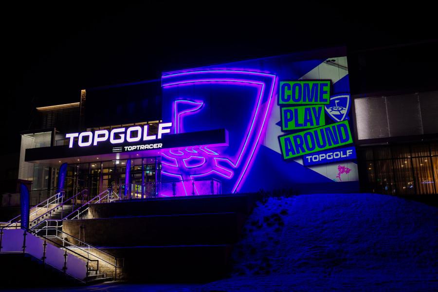 Topgolf exterior building, taken at nighttime lit with neon lights