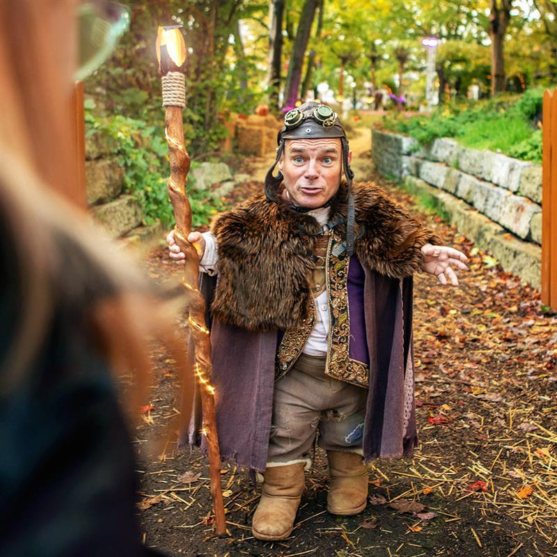 A performer with dwarfism portrays a fictional fantasy character during seasonal event at Heide Park Resort