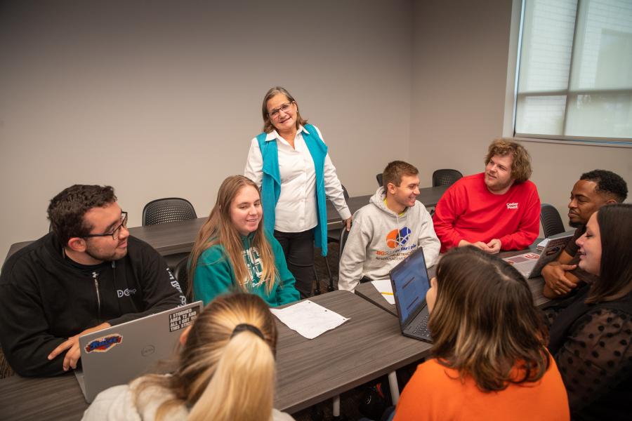 A group of students from Bowling Green State University's Resort and Attraction Management (RAAM) program having a discussion in a classroom