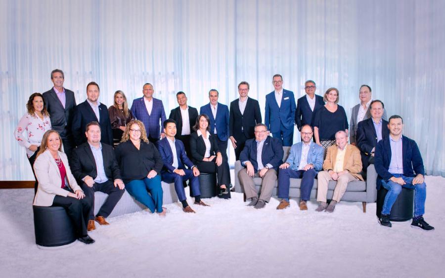 2024 Global Board of Directors pose together in front of a white curtain.