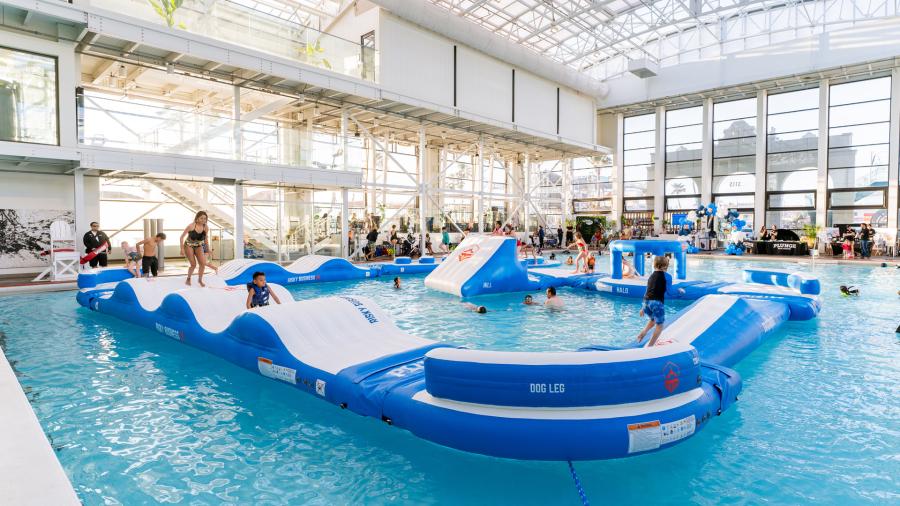 Inflatable obstacle course in a large swimming pool at The Plunge located within Belmont Park in San Diego