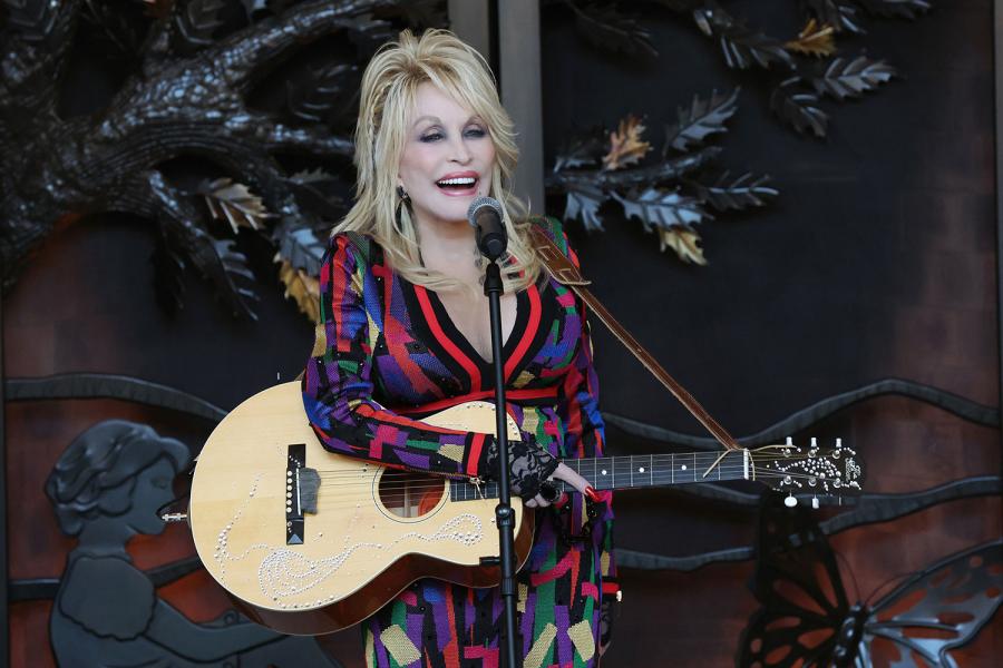 Dolly Parton performs in the hotel lobby during the grand opening of Dollywood's HeartSong Lodge and Resort
