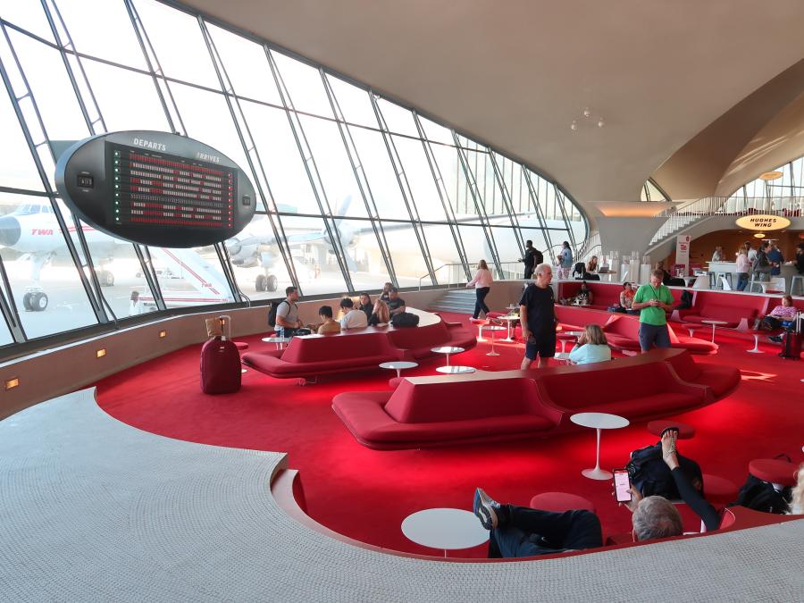 The Sunken Lounge at the TWA Hotel sports a retro look. Visitors can enjoy 1960s cocktail favorites and look out the windows to see the 1958 "Connie" plane.