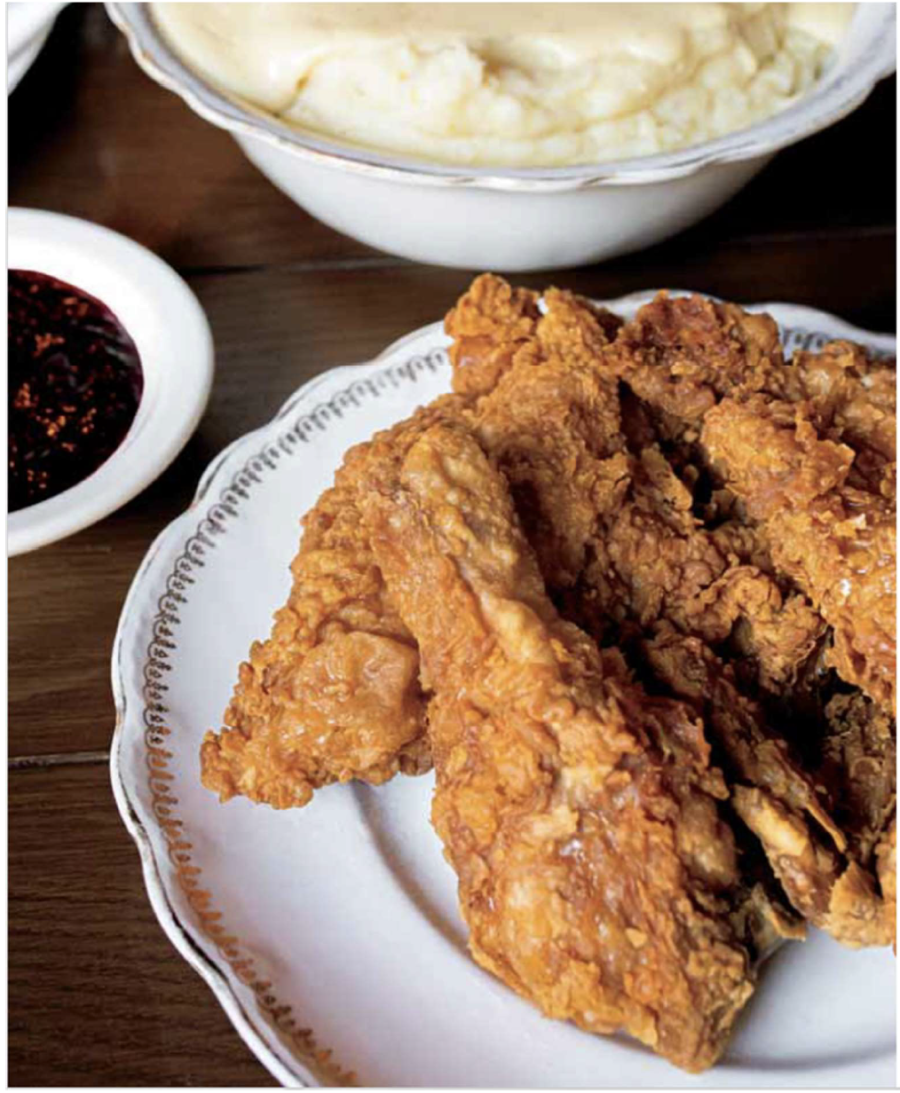 Fried chicken, cranberry relish, and mashed potatoes on a dinner table