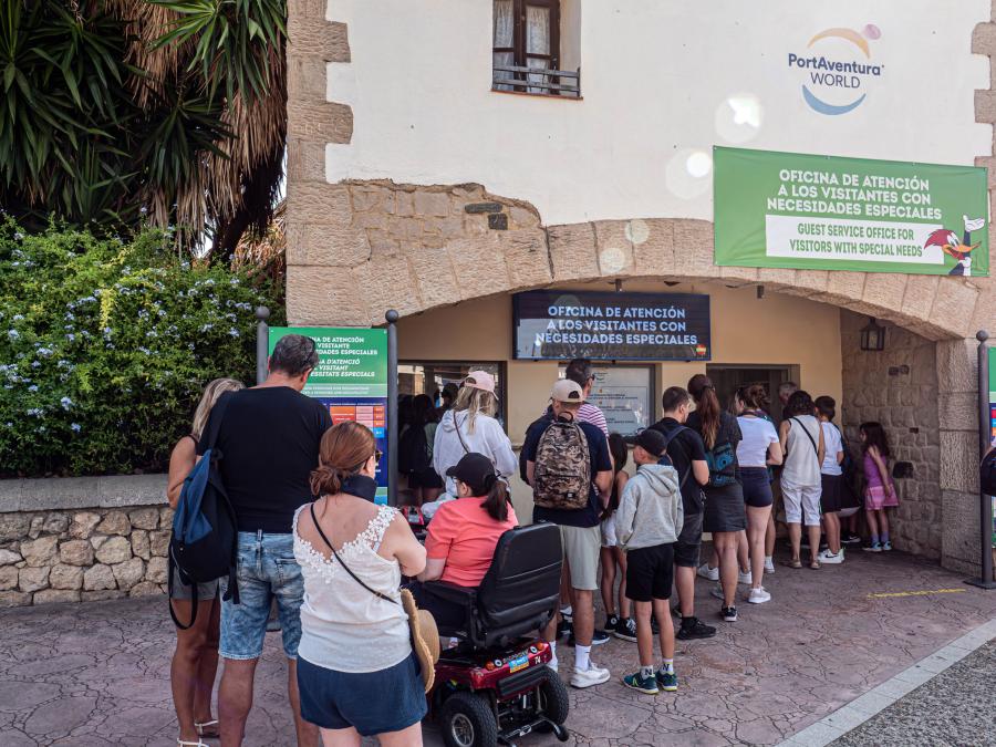 People waiting in line at the Guest Service Office for Visitors with Special Needs counter at PortAventura
