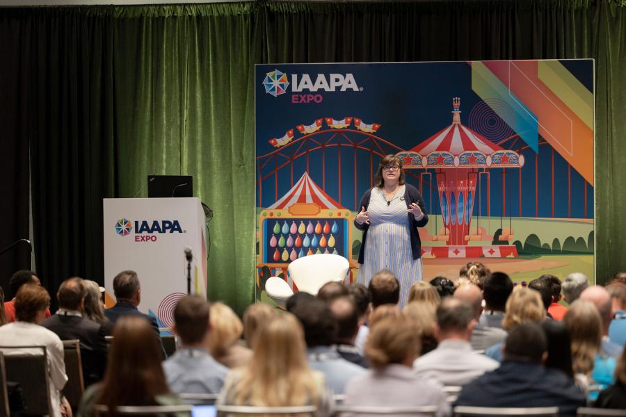 Palestrante Lauren Tidmore, Ed.D. está em um pódio durante a sessão EDUS Fix Your Trainwreck realizada na IAAPA Expo 2023