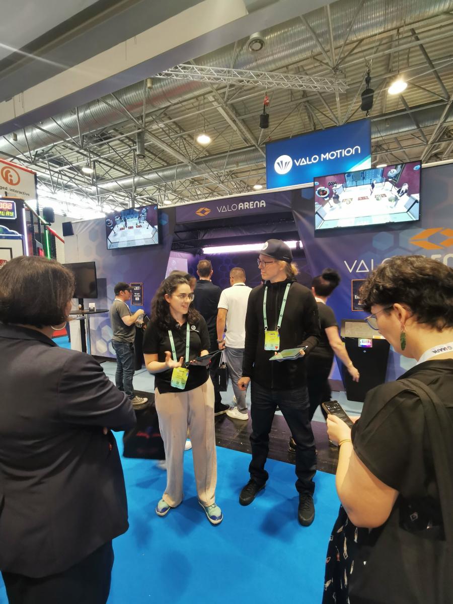 Tradeshow demonstrators at Valo Motion booth inside IAAPA Expo Europe 2023