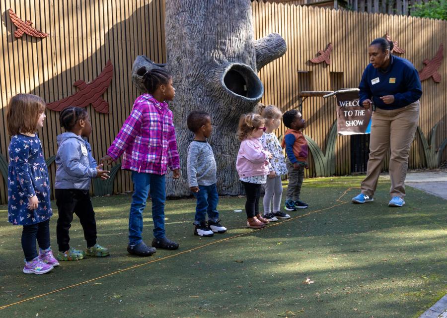 A Zoo Atlanta employee prepares an engaging activity for children