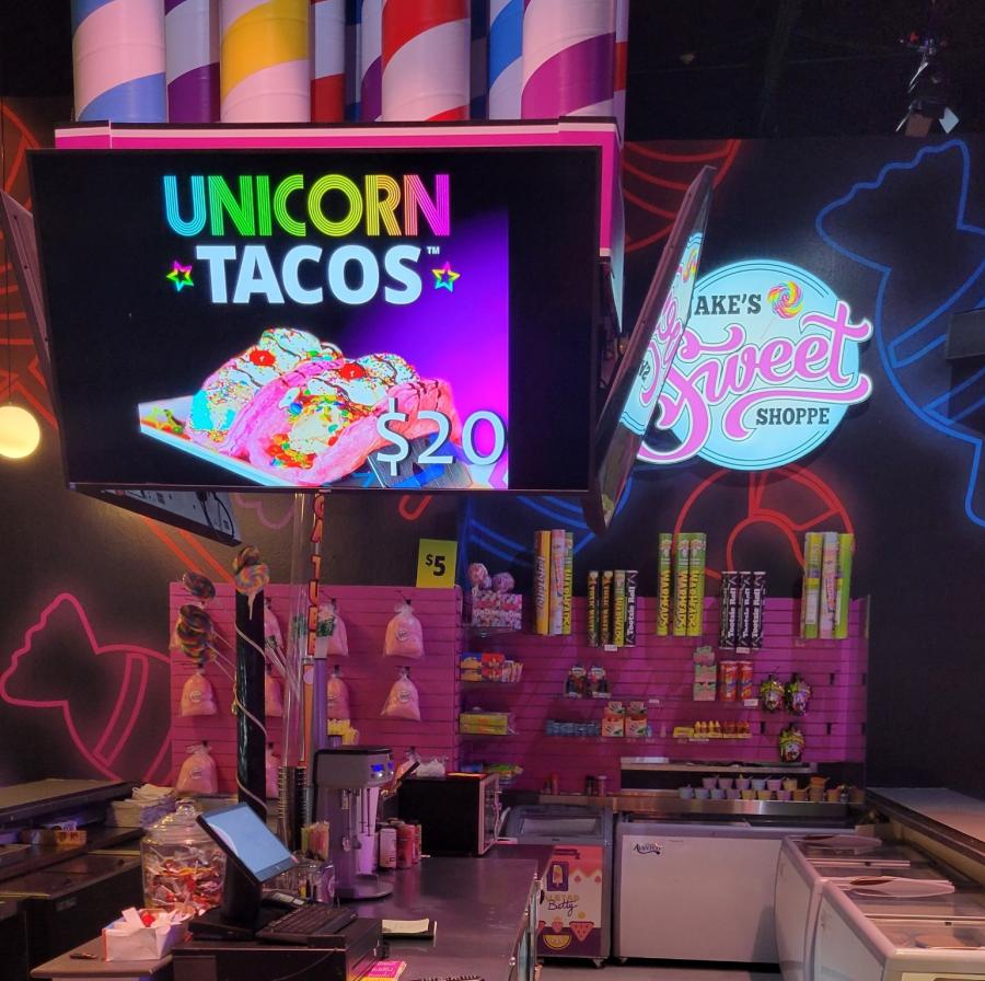 A candy shop stand advertising Unicorn Tacos at Jack's Unlimited FEC.