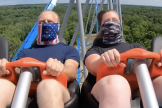 Riders wear masks on a roller coaster at Kings Island