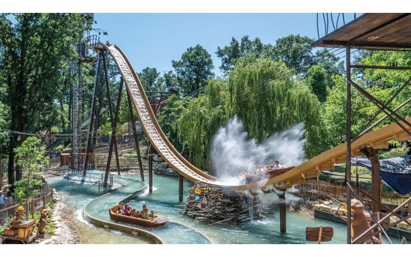 Action image of the Familypark water-log attraction Biberburg (Beaver Castle). The flume ride lodge takes guests up high at 17 meters, then rushes down with a big splash.