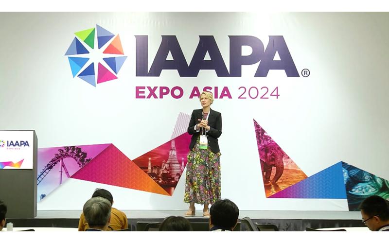 Speaker Peta Wittig, owner and director of Peta Wittig Consulting, is standing on a podium during her EDUSession held at IAAPA Expo Asia 2024